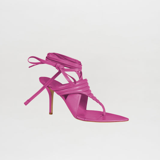 The Dalila Heels Magenta feature a bold pink hue, square toe, strappy Italian calf leather design, and ankle wrap ties, shown against a plain white background.