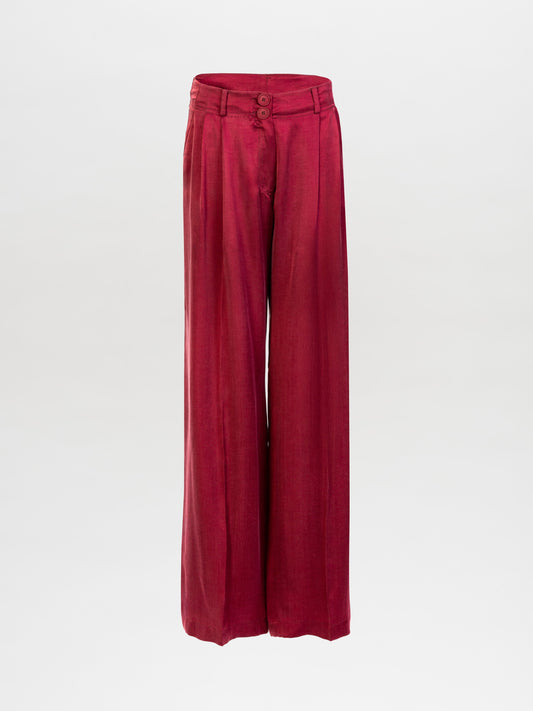 The Opal Pant is a high-waisted, wide-leg red trouser made from premium Italian fabric with front pleats, belt loops, and a double-button closure, shown on a plain white background.