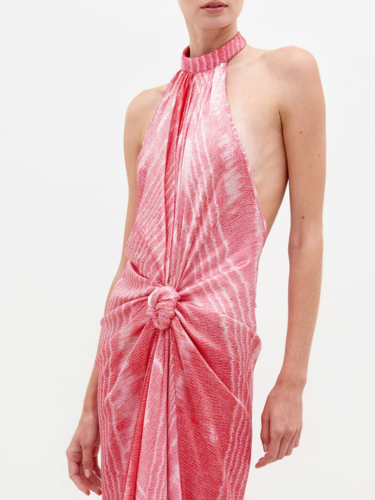 A person stands against a plain background wearing the Theodora Dress in color Peony Moire