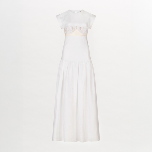 A Hanane Dress White with lace trim and a fitted silhouette.