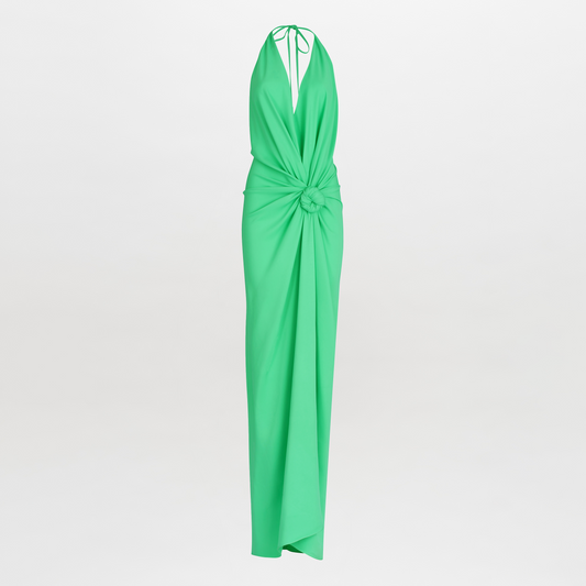 A woman in a Jazmin Dress Seafoam with a halter neckline and a knotted design at the waist, standing against a white background.